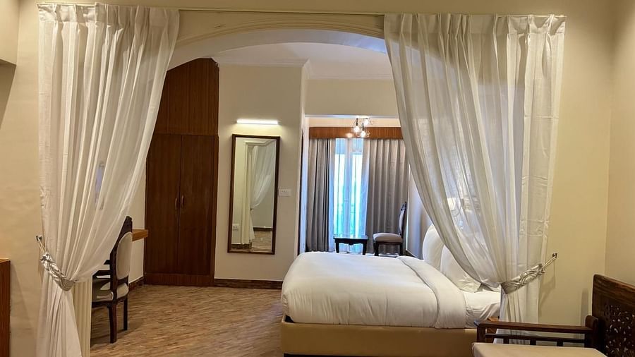 Image of the plush bed through the curtains separating the lounge space from the bedding space