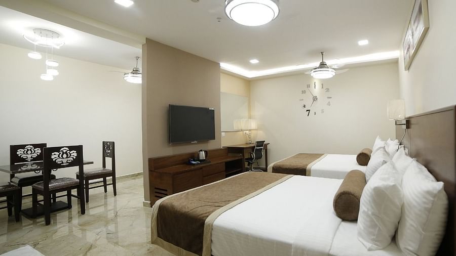 image of the family suite with twin beds and a dining table for its guests in voyage annapurna de royal, guntur