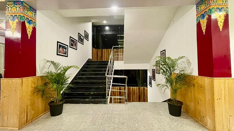 Staircase in the lobby area that has vibrant wall decor | Voyage The Royal Retreat, Gangtok
