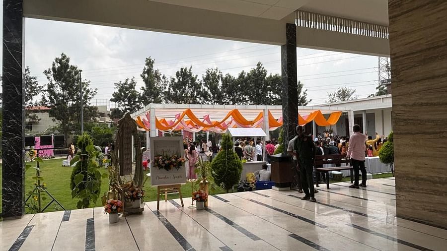 The main entrance of a wedding venue with floral details, opening into a lush garden setting. - VRR Astoria Hotel and Conventional Centre