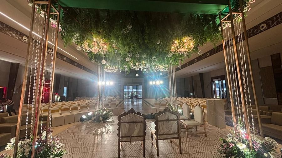 A wide-angle view of the hall featuring a combination of two seating  chairs, with floral decorations throughout.