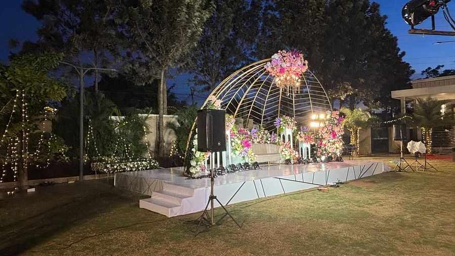 A picturesque wedding ceremony setup with a floral archway and greenery.