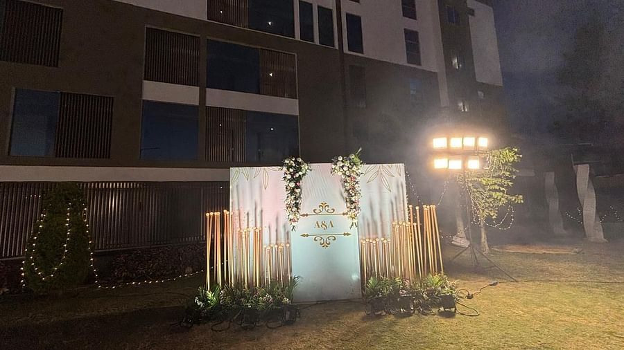 A picturesque wedding ceremony setup with a floral archway and greenery.
