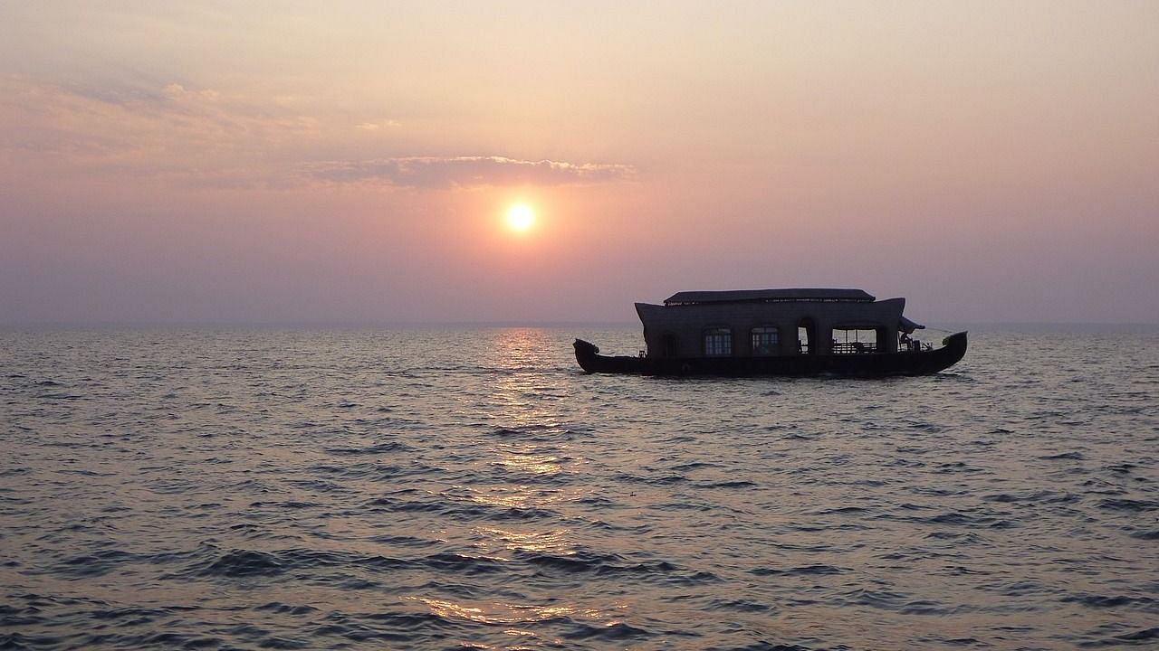 Image of a cruise sailing across the river during sunset.