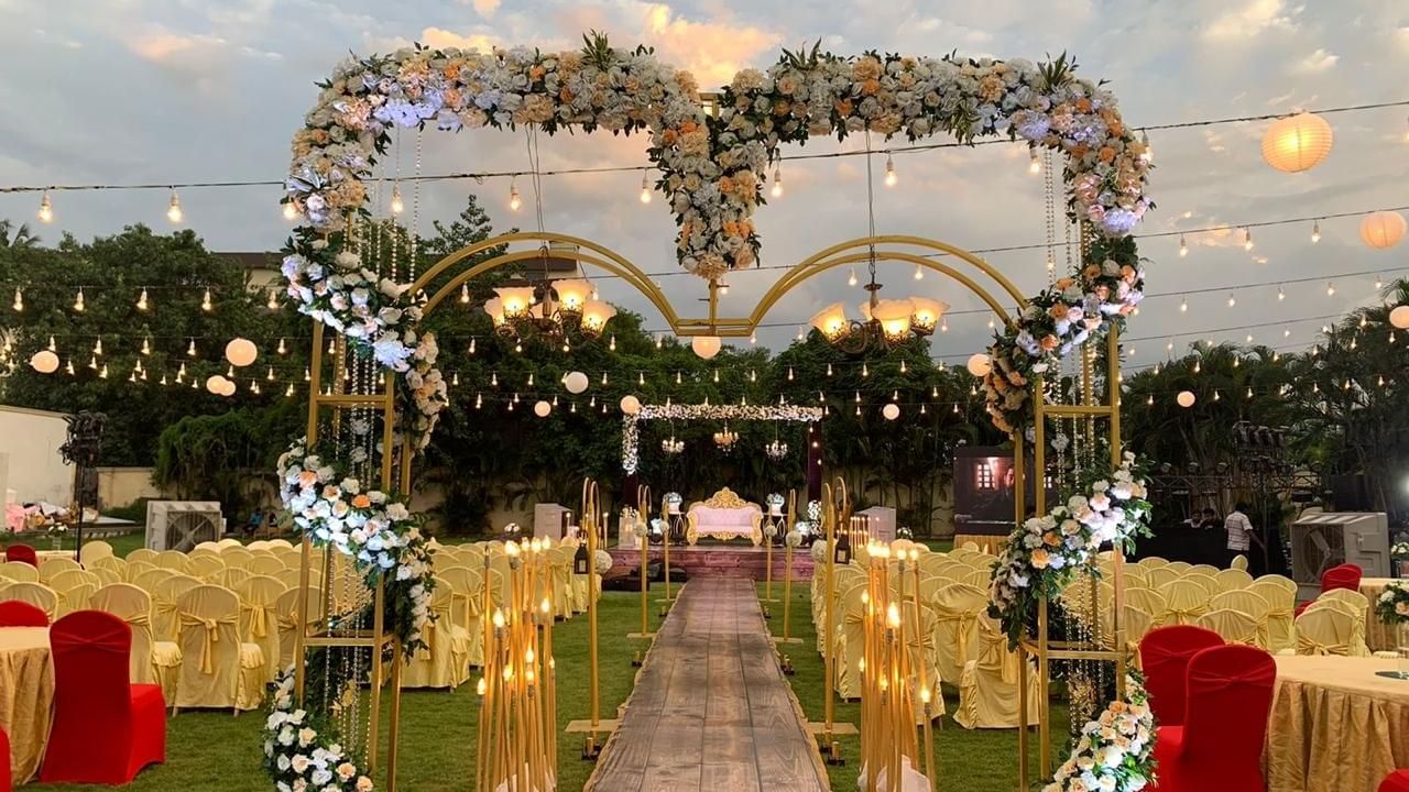 Elegant wedding entrance with heart-shaped floral arch and glowing lights at Ilara Hotels & Spa, OMR, Chennai