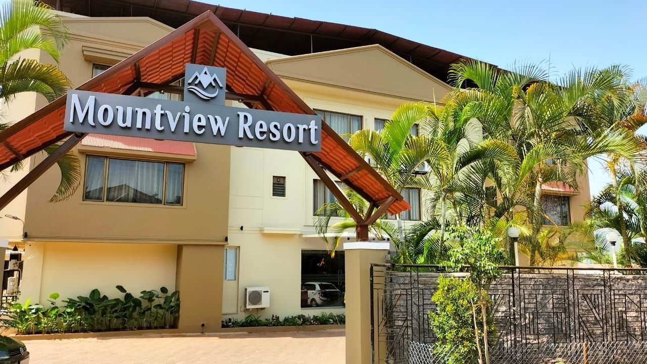Mountview Resort entrance in Lonavala featuring lush greenery, spacious driveway, and clear resort signage for a welcoming first impression.