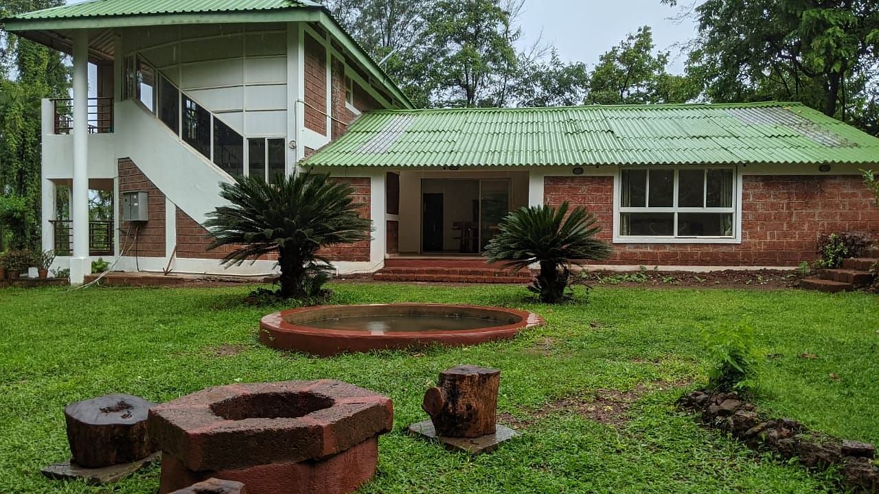 Exterior view of The Conservancy Bungalow with a green roof and a firepit in the lawn.