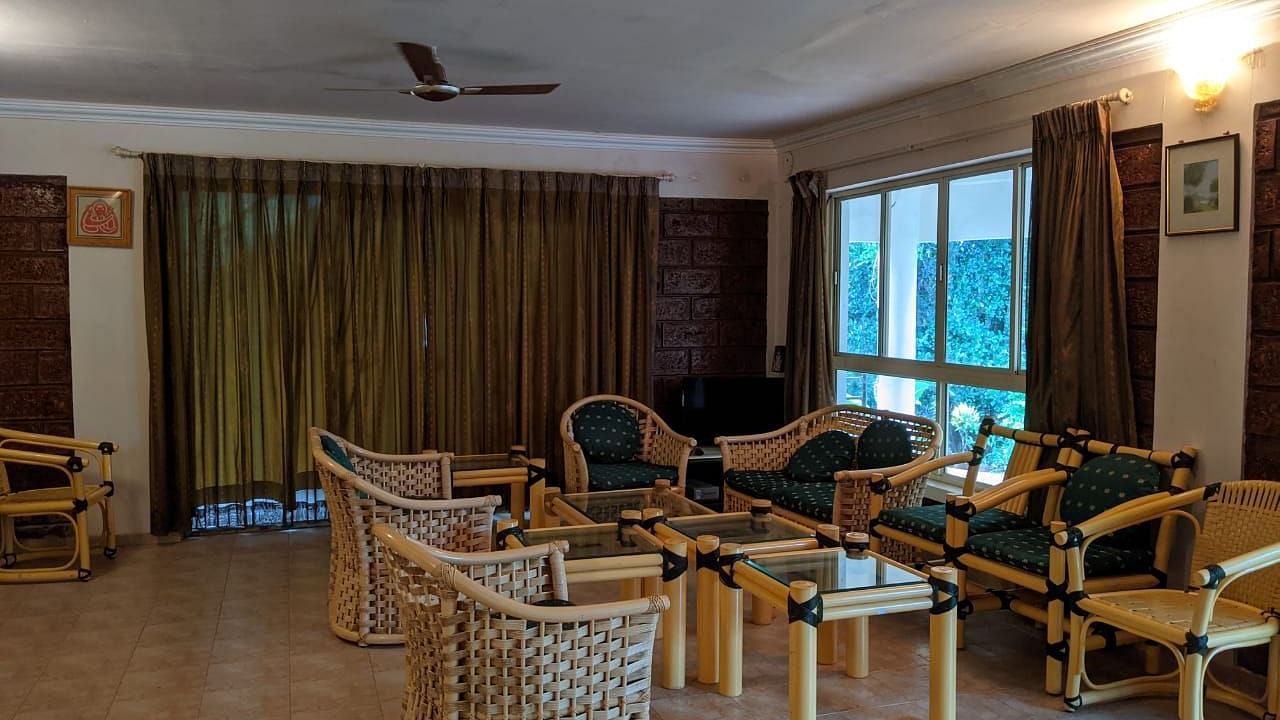 Spacious indoor lounge with multiple seating arrangements and large windows at The Conservancy Bungalow.