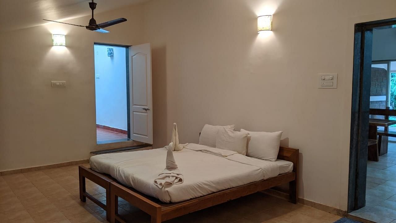 A bedroom with a minimalist design and a bed at The Conservancy Bungalow.