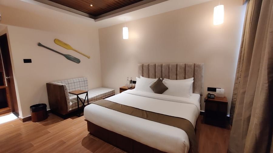 Stylish bedroom with a king-sized bed, wooden flooring, and soft lighting - Arina Island Resort, Swaraj Dweep