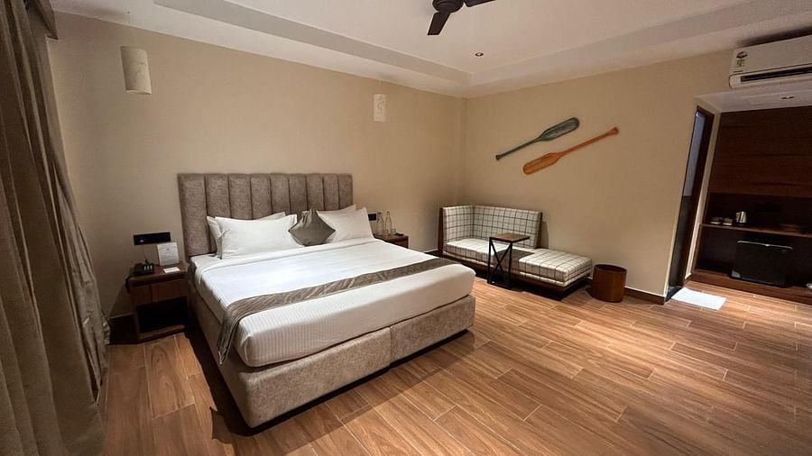 Spacious bedroom featuring a king-sized bed, wooden flooring, and elegant lighting - Arina Island Resort, Swaraj Dweep
