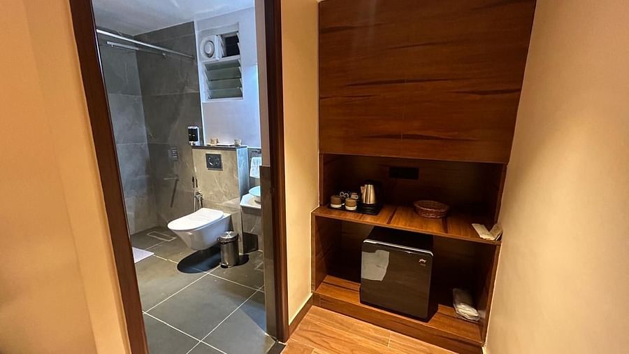 Modern bathroom with sleek wooden accents and a spacious shower area - Arina Island Resort, Swaraj Dweep
