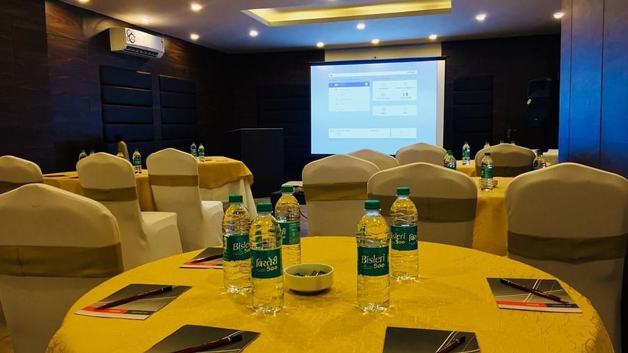 Image of a round table with water bottles and notepads placed on it at Calux Grand Baga.