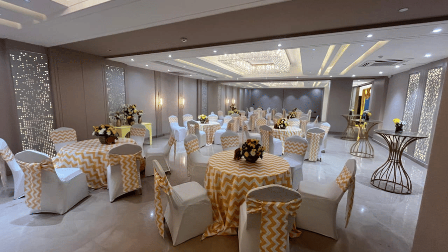 A wide-angle shot of the Sapphire Hall beautifully decorated for an event in a brightly lit banquet hall at Hotel 91 Privé, Gurugram.