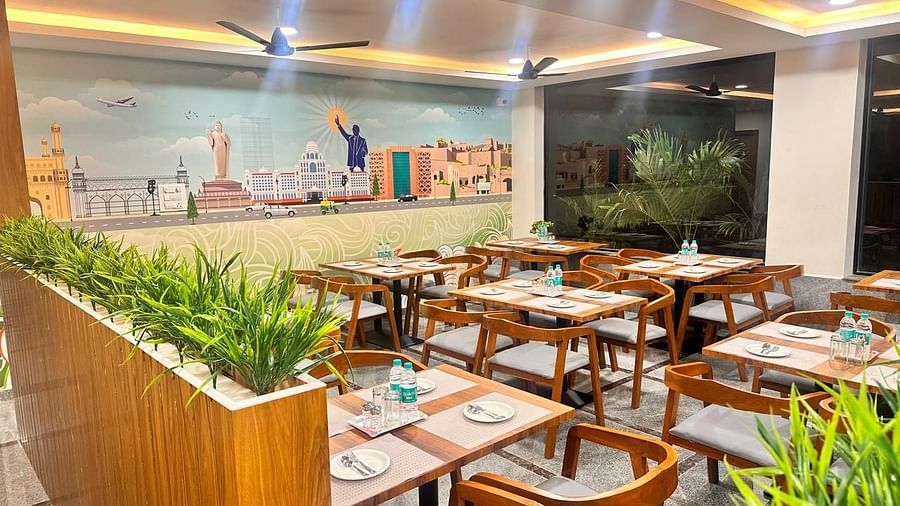 An image of a restaurant where many tables and chairs are arranged | Hotel Aerotel, Hyderabad