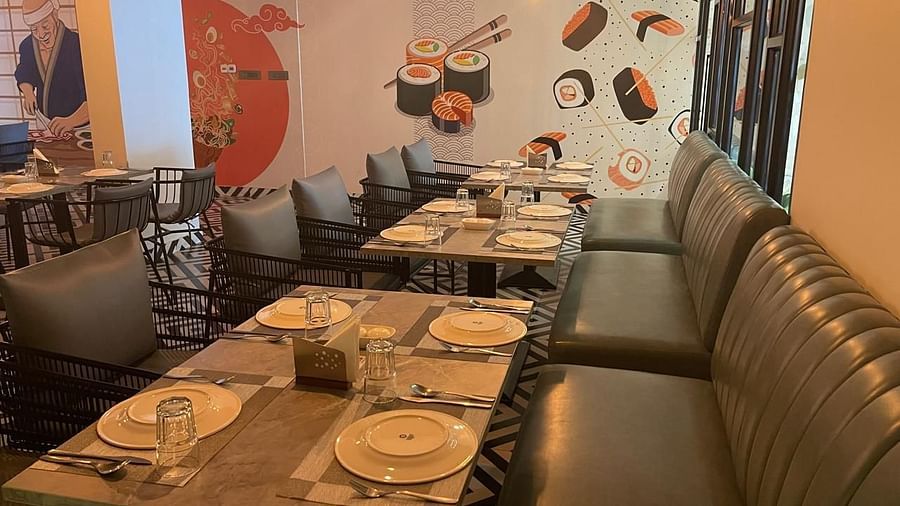 Dining area with booth seating and colourful wall art at Hotel Kyzen HiTech City – Your Zenly Stay