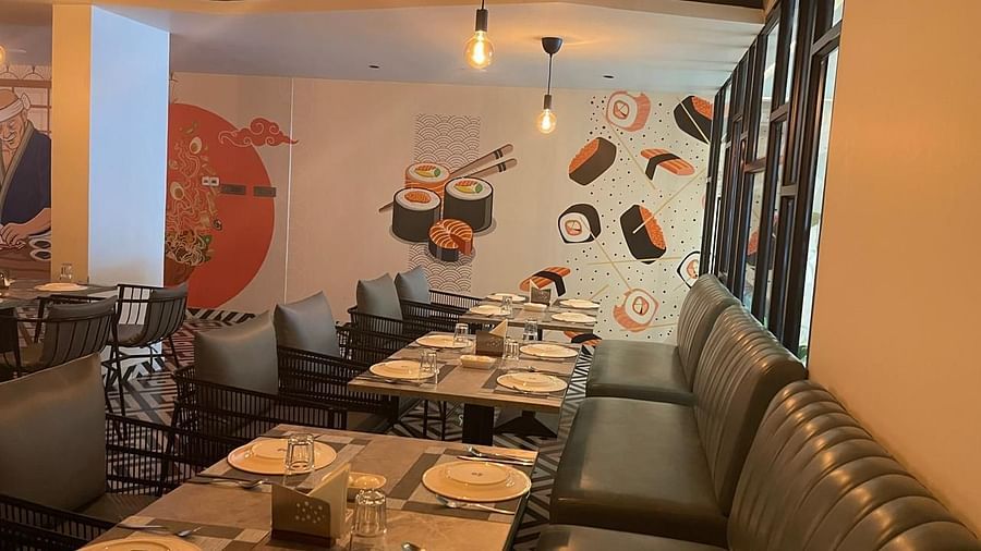 View of the dining space with booth seating and a modern ambience at Hotel Kyzen HiTech City – Your Zenly Stay