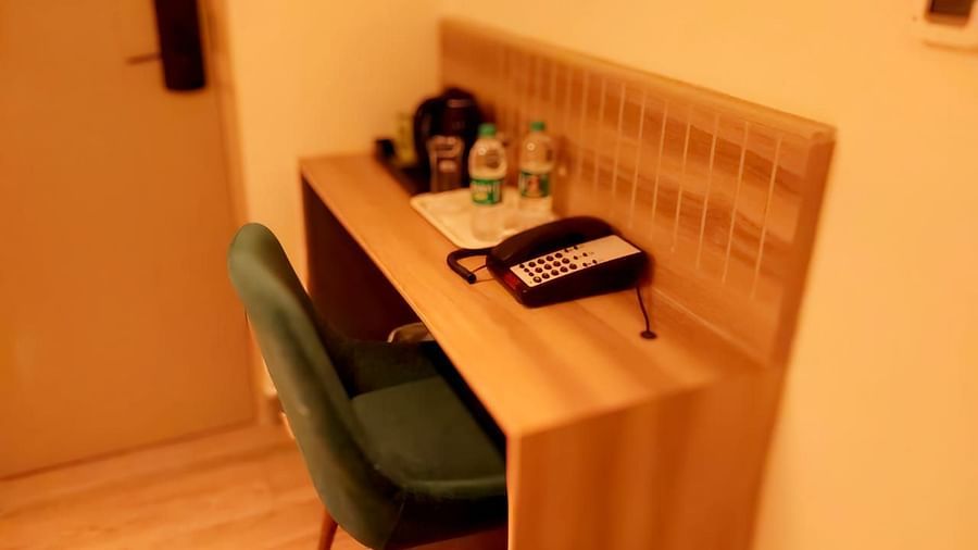 Image of a room with study area equipped with a chair and a table.