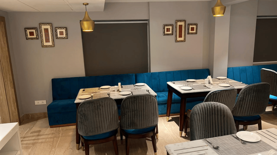 Elegant dining area with comfortable seating and contemporary interiors at Hotel Southgate Goa, Calangute, creating a welcoming setting for guests to enjoy meals.