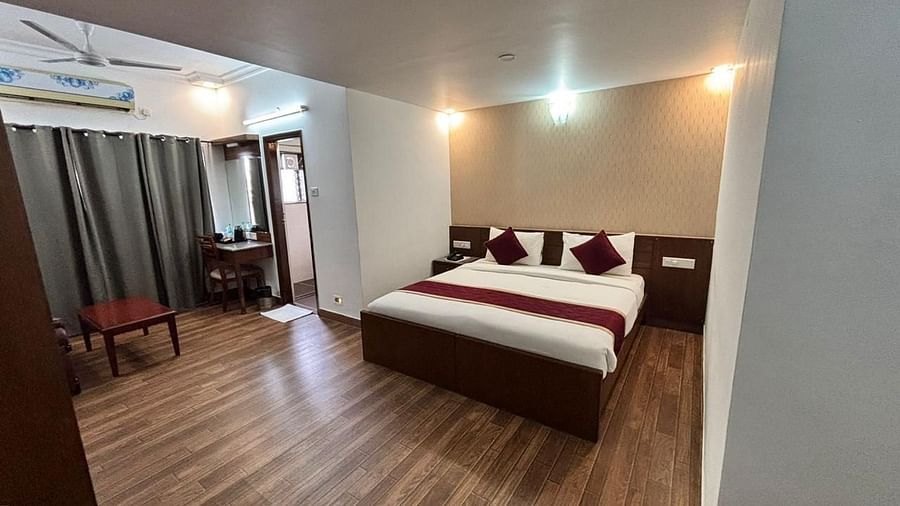 A spacious bedroom with a large bed and ample walking space ensures a comfortable and relaxing stay at Lords Midtown Suites.