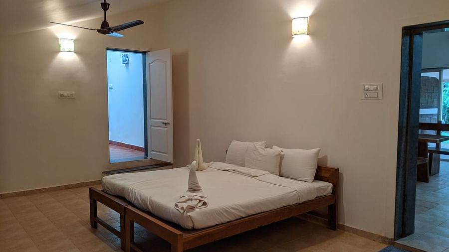 A bedroom with a minimalist design and a bed at The Conservancy Bungalow.