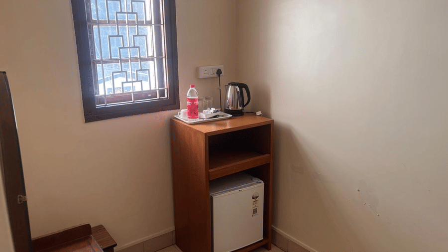 A dedicated nook featuring a wooden stand with an electric kettle and a minibar | Trance Sunderban Resort