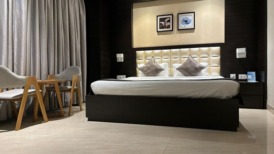 a view of king bed and a work desk of Premium Colony King bed room at Wonder country club resort