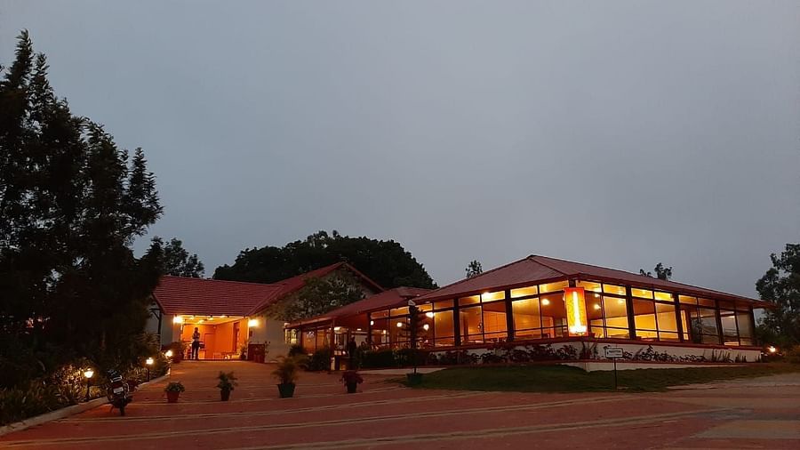 An evening view of Woodstock Resorts, Coorg highlighting the outdoor lighting and architecture.