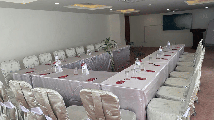 A banquet hall, windows with curtains and TV