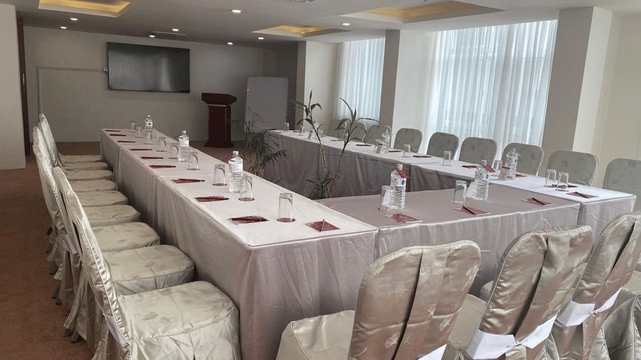 A banquet hall, windows with curtains and TV