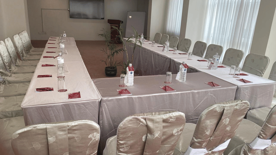 A banquet hall, windows with curtains and TV
