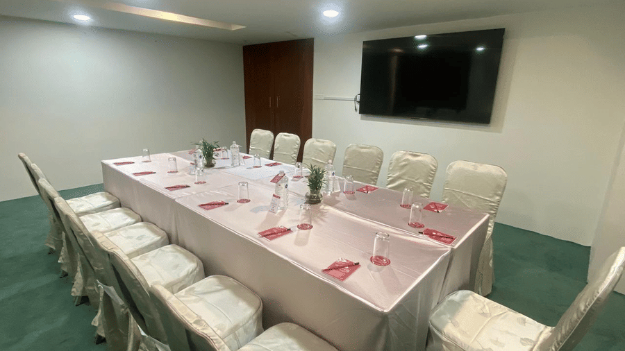 A banquet hall with a TV and ceiling lights