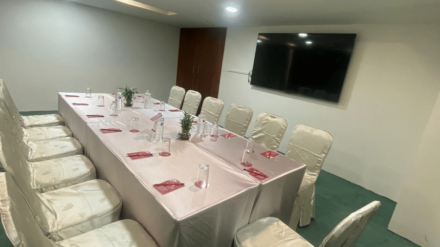 A banquet hall with a TV and ceiling lights