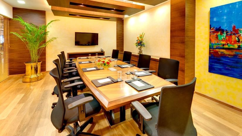 A meeting room with a table surrounded by chairs - Kenilworth Hotel, Kolkata