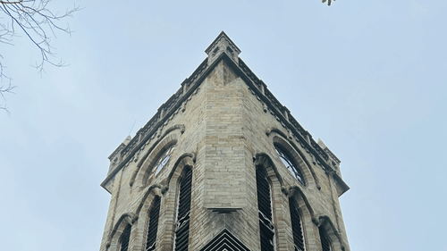 A view from below of the Christ Church in Kasauli with the stone wall in view