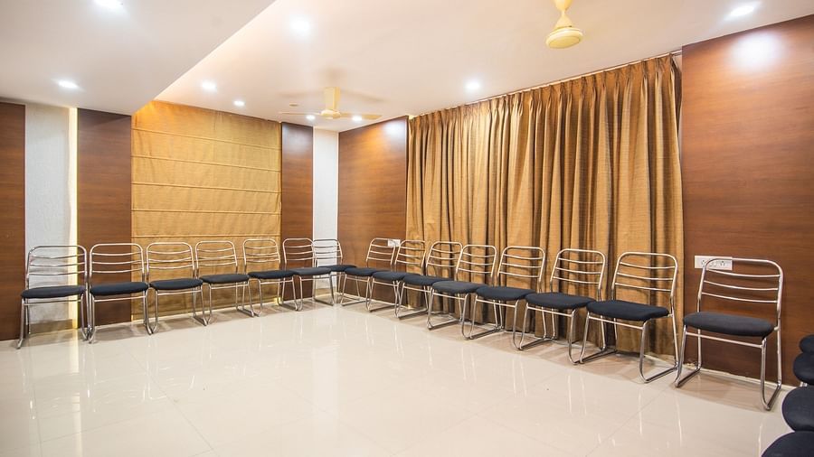 Conference hall with chairs lined up against thr wooden ply walls and golden curtains - Hotel Morya, Bhopal