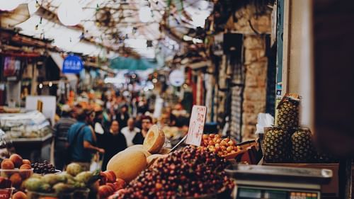 An image of a crowded market where people are seen shopping