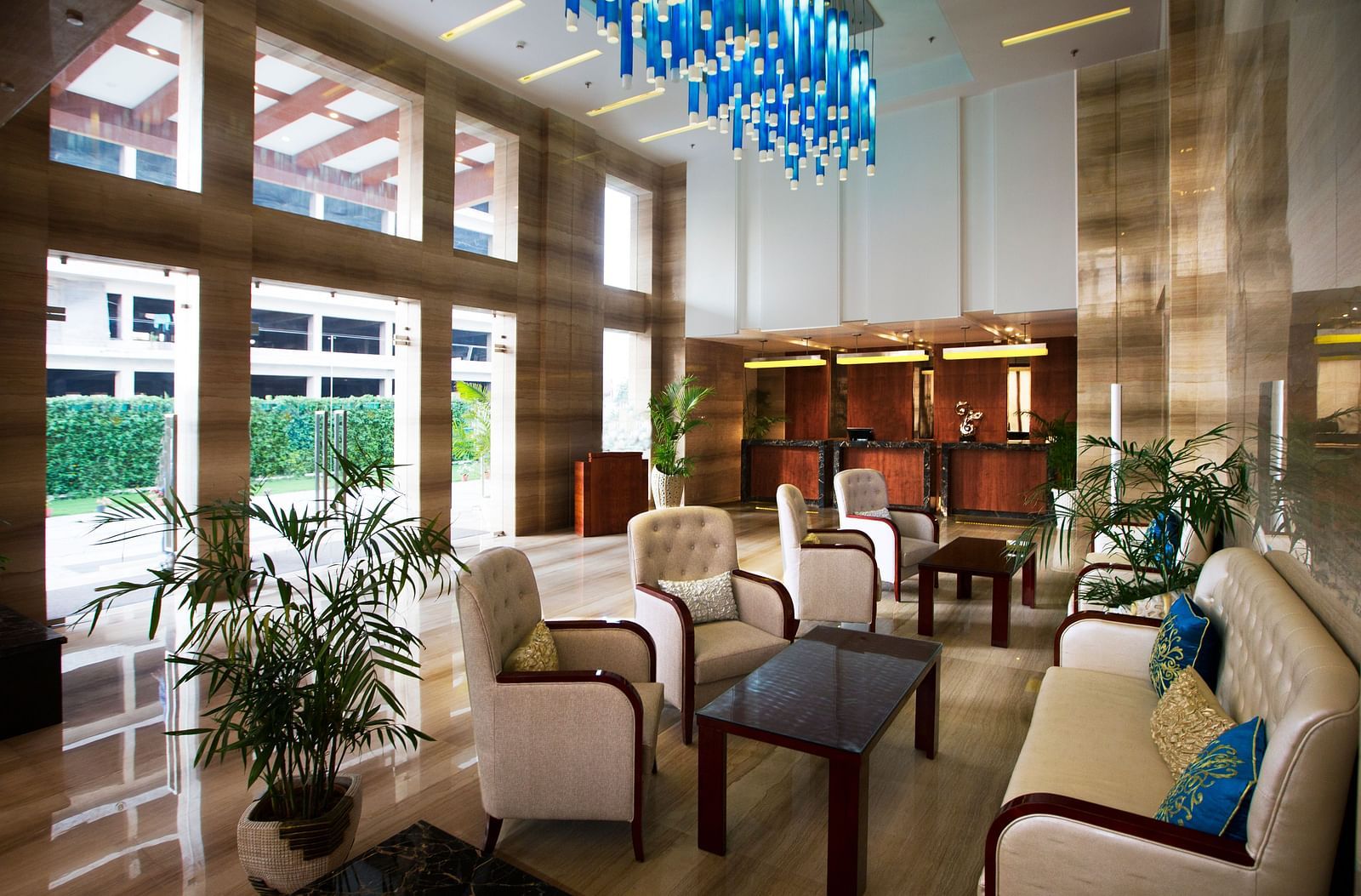 A lobby with a common seating area along with a beautiful chandelier hanging from the ceiling - Ramada by Wyndham, Ghaziabad, Vasundhara