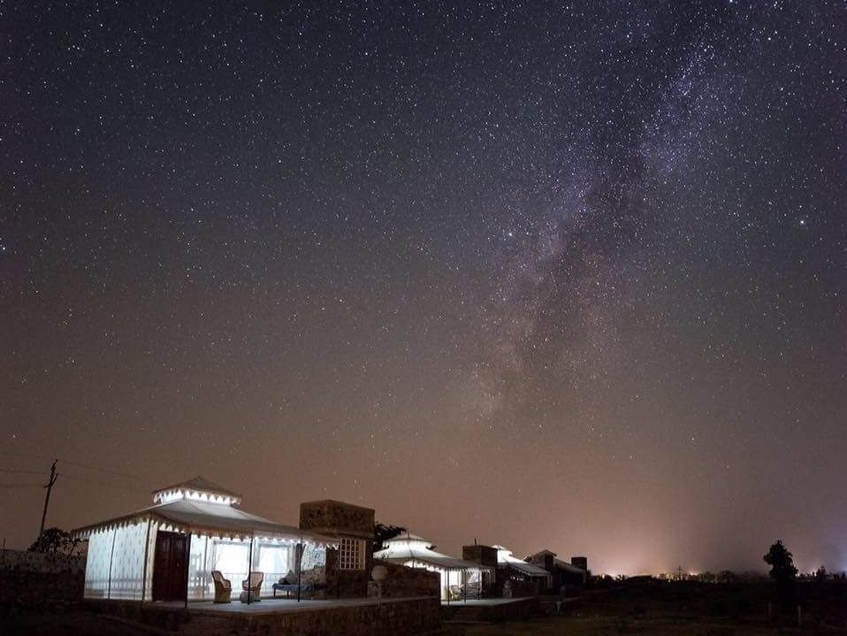 A facade image of the Utsav Camp Sariska which is brightly lit
