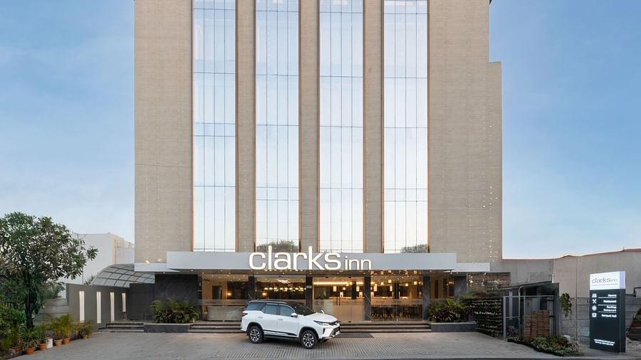 Clarks Inn hotel, a multi-story building with a contemporary design and a glass facade.