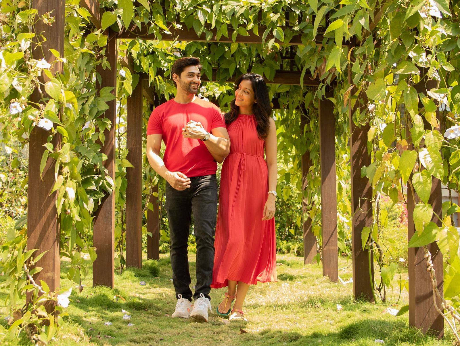 an image of a couple walking through green pathway in garden - Rhythm Lonavala