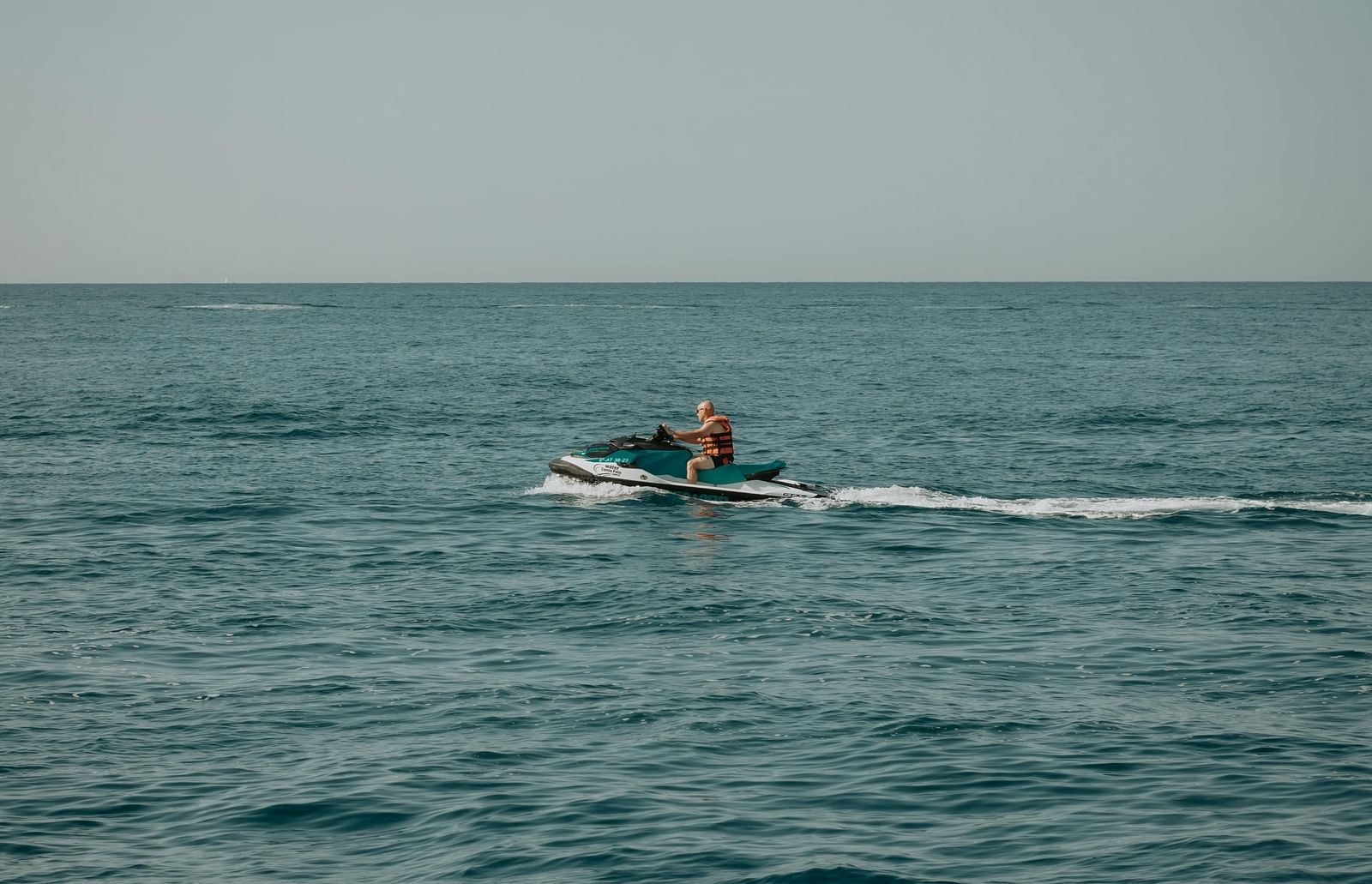 A person riding a jet skii on the ocean.
