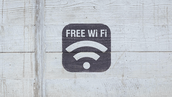 Free WiFi signage displayed on a concrete wall.