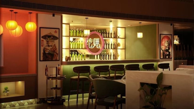 Bar counter at Hanami Restaurant, Uday Suites, with stylish lighting and modern interiors.