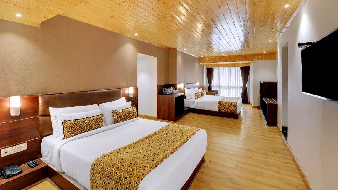 An image of a room with two queen size beds, TV and minimal decoration - Sumitel Vista TV Tower
