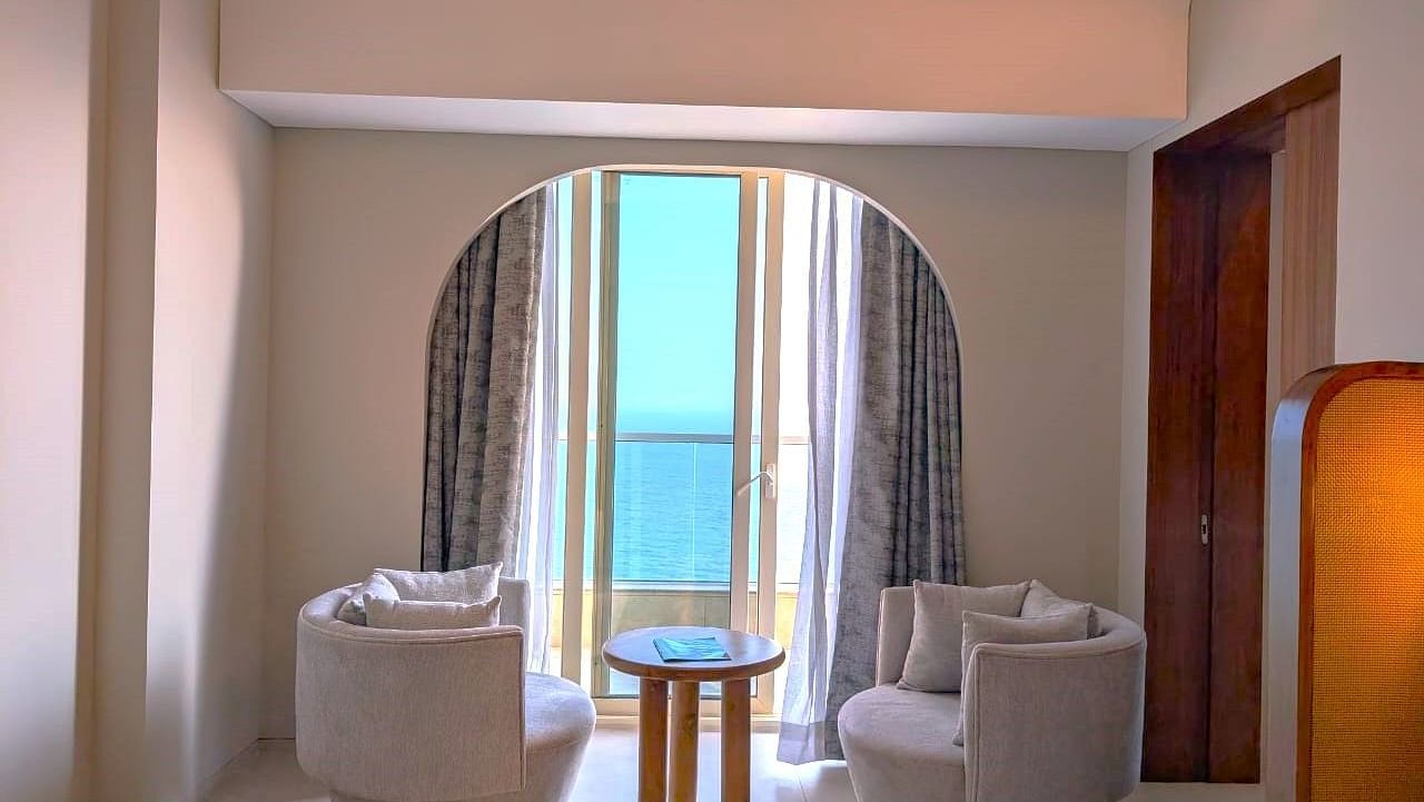 A sit-out area at Swosti Premium Beach Resorts, Puri, with comfortable seating and views of the ocean.
