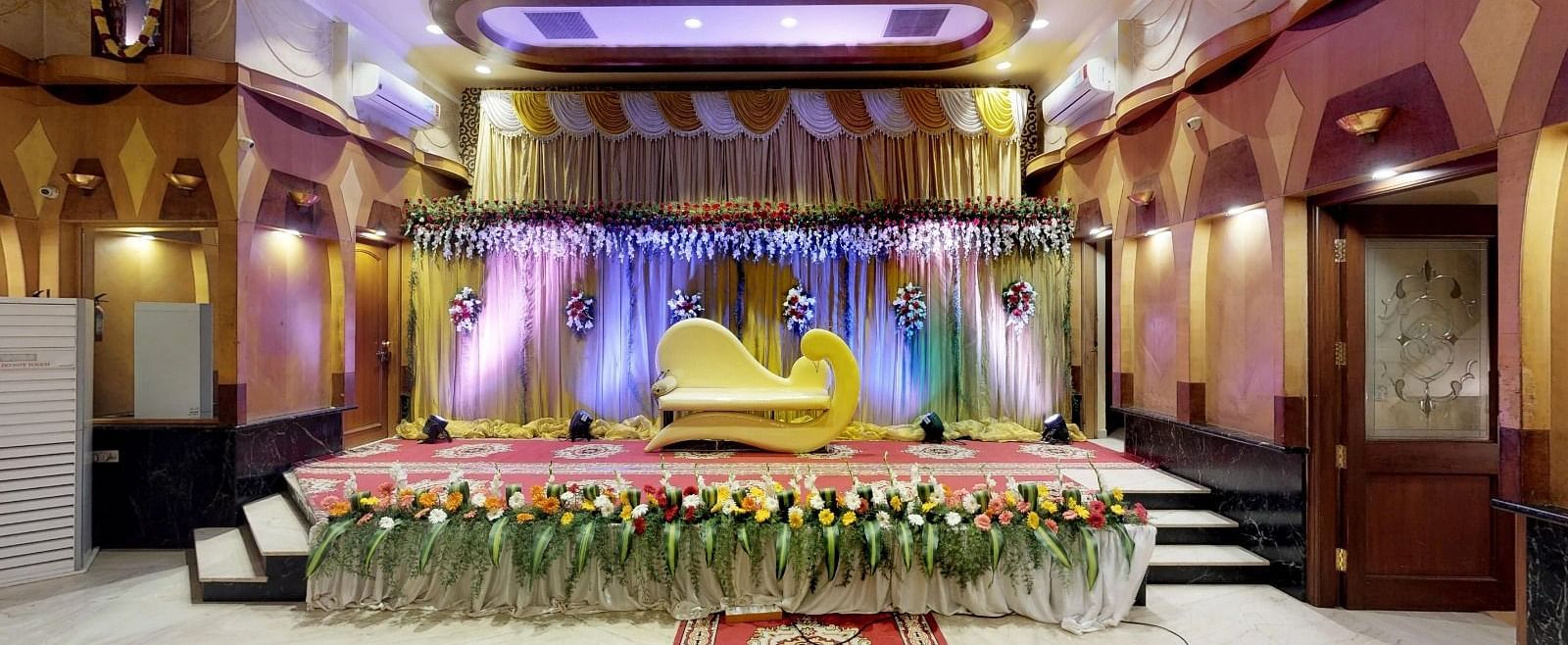 View of a brightly lit stage for a wedding occasion in Sammilan Hall