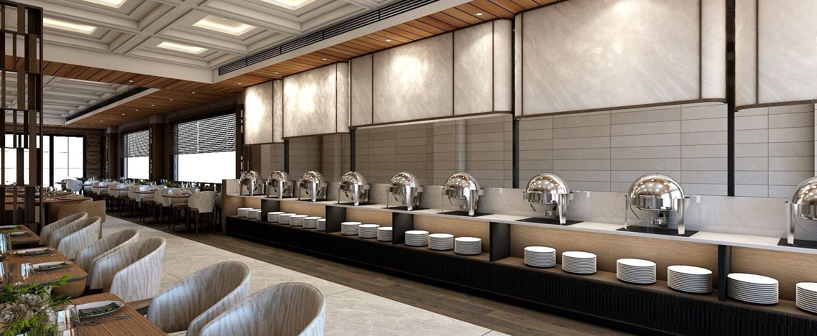 The buffet counter with various porcelain plates lined up together right behind the dining area of the restaurant - Namaste Corbett