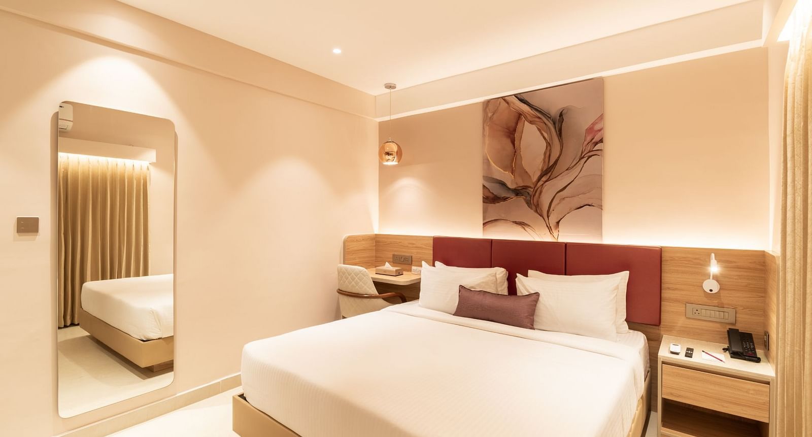 King-sized bed with elegant decor in The Premium Rooms at Livancia The Sojourn, Bangalore.