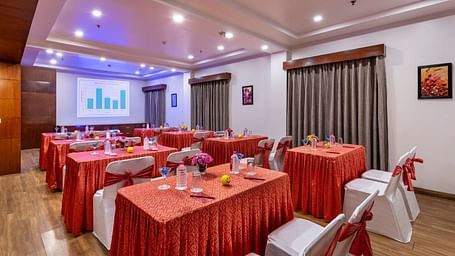 Spacious banquet with ample seating arrangement, grey long curtains and good audiovisual at Lords Plaza Jaipur.